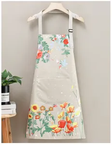 Detail view of floral print kitchen apron with convenient front pocket and adjustable straps.
