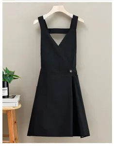 Detailed view of the black waterproof cross-back apron, featuring a handy pocket.