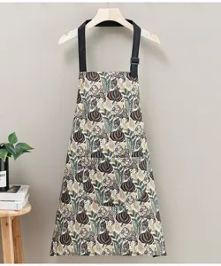 Floral kitchen apron for cooking with adjustable straps and front pocket for home restaurant use.