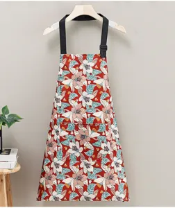 Stylish floral kitchen cooking apron with adjustable strap and front pocket for home use.