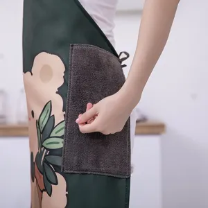 Waterproof kitchen apron with cute bear pattern and absorbent towel pocket for home cooking.