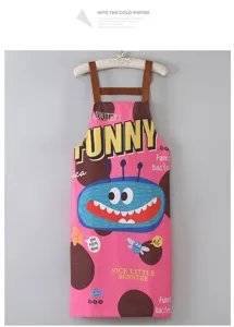 Detalles de delantal de cocina con estampado de monstruo, tela rosa con tirantes marrones, cocina.