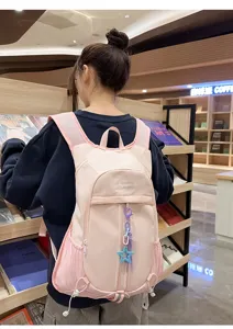 Detailed view of the pink casual outdoor backpack, showcasing front pocket design and star charm.