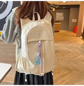 Detailed view of the casual mountain backpack featuring a cute cat ear design and pendant.