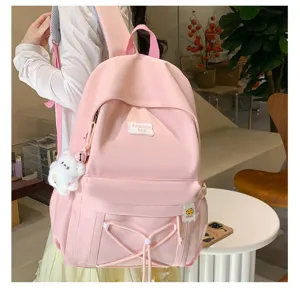 Pink student backpack sweet style school bag with cute pendant and front pocket design.
