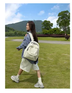 Detailed view of off-white casual canvas backpack with letter print for daily commute and travel.