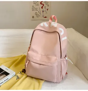 Cute pink casual backpack for women stylish soft travel daypack with front pocket aesthetic.
