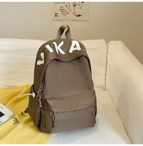 Casual brown backpack with front pocket and white VIKA letter print for daily travel use.