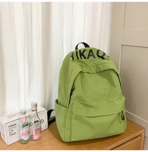 Avocado green canvas casual backpack with letter print, stylish daily school bag for students.