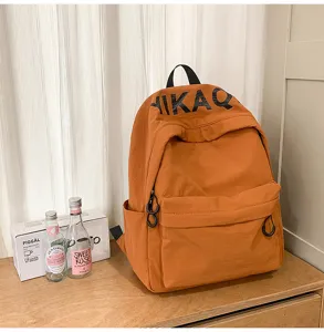Orange casual backpack, stylish daily commute school bag with spacious front pocket and zippers.