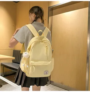Details of the yellow canvas backpack, lightweight student school bag, campus style design.