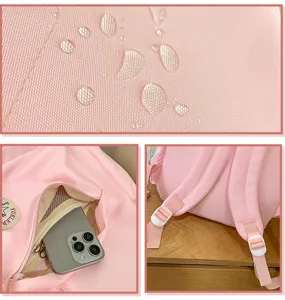 Pink school backpack detail view showing waterproof fabric, zipper front pocket, and adjustable straps.