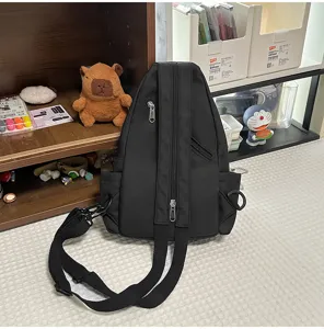 Black multi-function chest backpack detail showcasing double shoulder straps and metal zippers