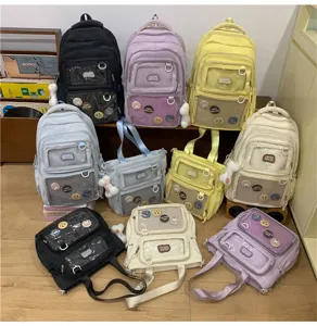 Detail shot of multi-color canvas backpack and tote bag with clear pockets and cute pins.