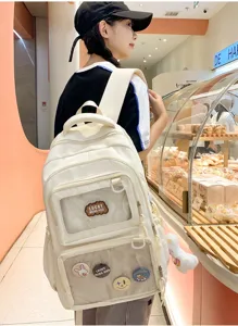 Casual white ita school backpack with clear front pocket, large capacity student bag detail.