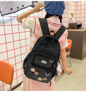 Black large capacity student backpack with transparent front pocket and cute pins for daily use.