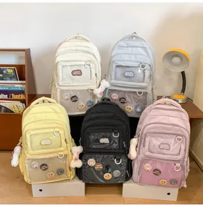 Clear front pocket ita backpack detail view, multi-color student school bag display scene.