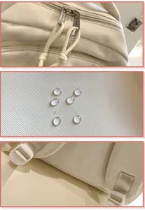 Detail view of beige canvas backpack featuring smooth zippers, waterproof fabric and durable straps.
