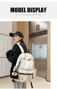 Casual vintage tie-dye large capacity canvas backpack with cute plush pendant for school travel.
