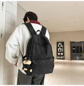 Retro casual black backpack scene detail, spacious daily school bag with cute pendant.