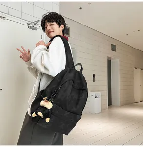 Casual camouflage backpack with cute dog charm, large capacity and lightweight design.