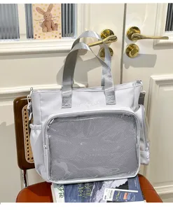 Detail view of Japanese ins style ita shoulder bag with transparent mesh front pocket and silver straps.