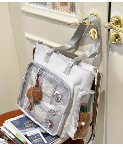 White canvas itabag shoulder bag with clear PVC display window and cute bear pendant style.