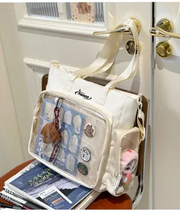 Detailed view of Japanese ins style campus itabag shoulder bag with clear front pocket for anime pins.