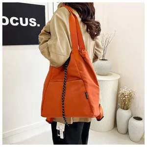 Detailed view of orange drawstring casual backpack and shoulder bag for daily commute use.