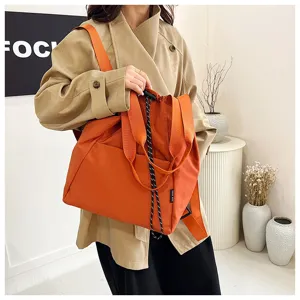 Orange drawstring canvas backpack detail view, casual commute multi-functional shoulder bag