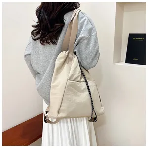 Casual canvas drawstring backpack for women, multi-way shoulder bag for daily commuting.