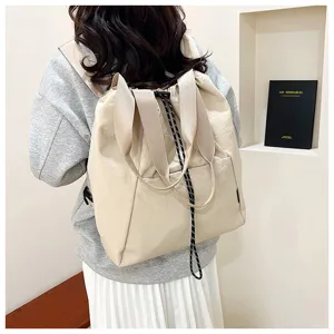 Casual canvas drawstring backpack for women, large capacity commuter sports shoulder handbag.