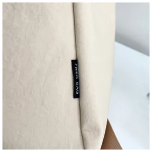 Close-up detail of the casual backpack fabric, showing durable texture and branded label.