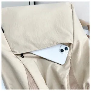 Detailed view of the casual beige drawstring backpack featuring phone storage for daily commute.
