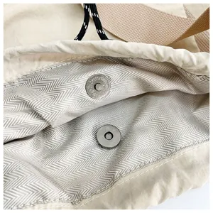 Detailed view of the casual drawstring shoulder bag interior with magnetic snap and lining.