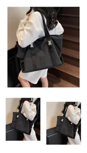 Black large capacity tote bag detail view, showing dual buckle straps and casual style.
