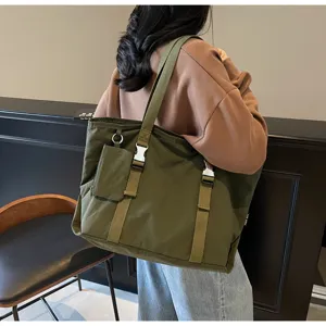 Casual large capacity canvas tote bag with buckles and small pouch for daily commuting.