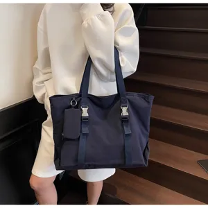 Large capacity dark blue canvas tote bag with front straps and cute mini pouch detail.
