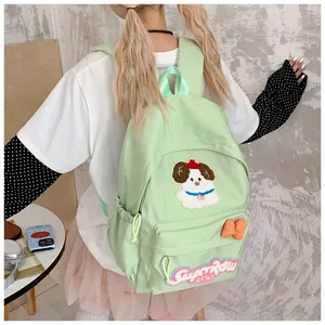 Cute green canvas school backpack with adorable dog embroidery and sweet bow decoration.