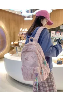 Stylish pink canvas backpack with cute print, large capacity casual daypack for students.