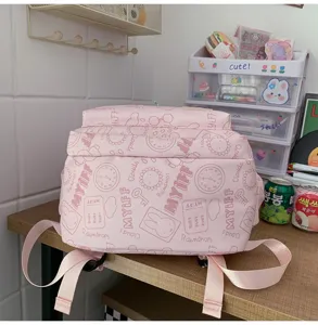 Pink cute aesthetic backpack for teen girls, large capacity school bookbag with playful prints.