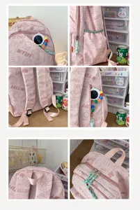 Detailed view of the pink student backpack showing front pocket, zippers, and straps.