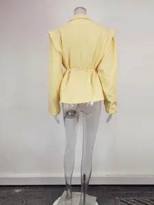 Back view of a solid pale yellow women blazer with waist tie and lapel collar detail.
