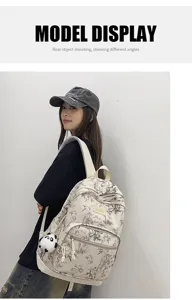 Canvas backpack with stylish bamboo print and cute panda pendant for travel and daily use.
