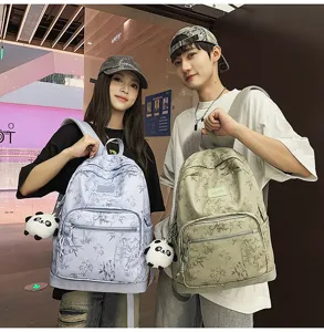Stylish bamboo print backpack with cute panda pendant, casual couple travel daypack for daily use.