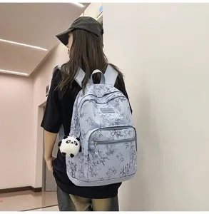 Lightweight casual blue bamboo print backpack with cute panda pendant for daily travel school.