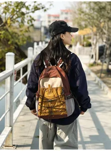 Lightweight outdoor travel backpack for women, multi-pocket design, durable hiking daypack.