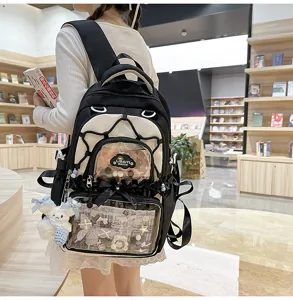 Detailed view of black and white ita backpack with clear front pocket in library setting.