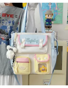 Cute Japanese style canvas shoulder bag with multi pockets, color block design and plush charms.
