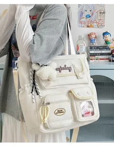 Japanese canvas messenger bag with multi pockets and cute plush pendant, casual school bag detail.